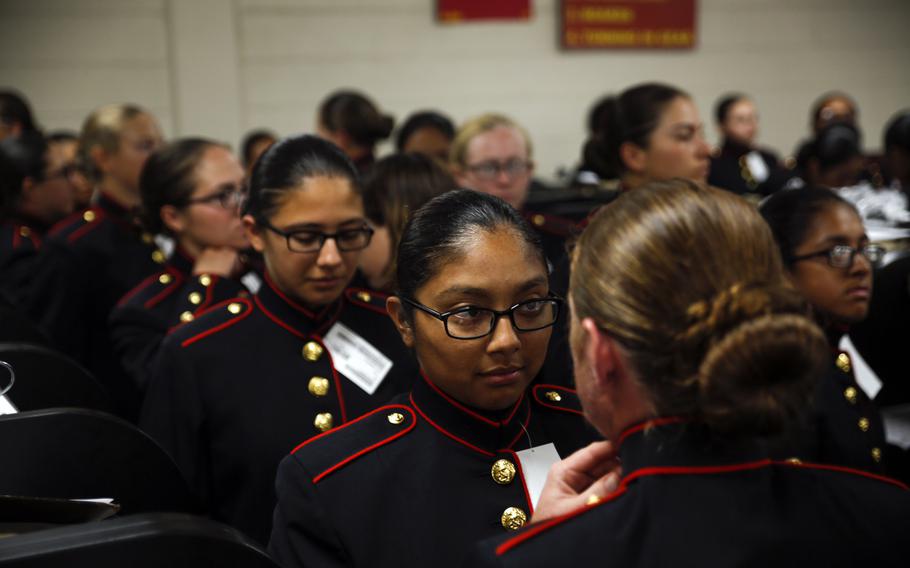 Recruits with Platoon 4040, Papa Company, 4th Recruit Training Battalion, try on their blue dress coats for the first time Aug. 21, 2018, on Parris Island, S.C.