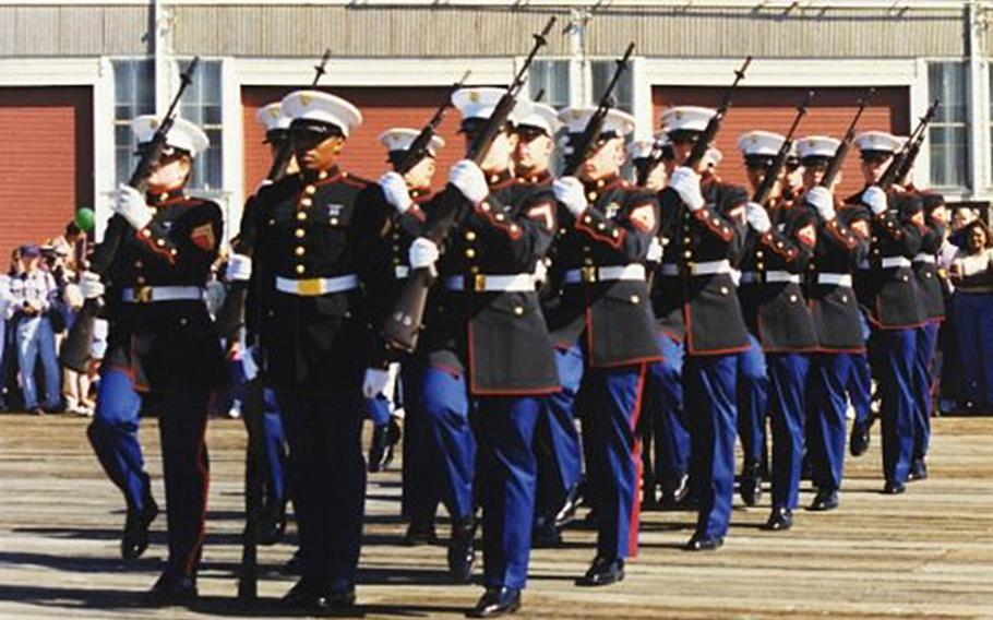 Pictured here during a performance at San Francisco's Fleet Week on Saturday, Oct. 10, 1998, are Marines of the silent drill team from Marine Corps Detachment, Defense Language Institute, Presidio of Monterey, Calif. The female Marines on the team were authorized to wear specially tailored male dress blues coats.
