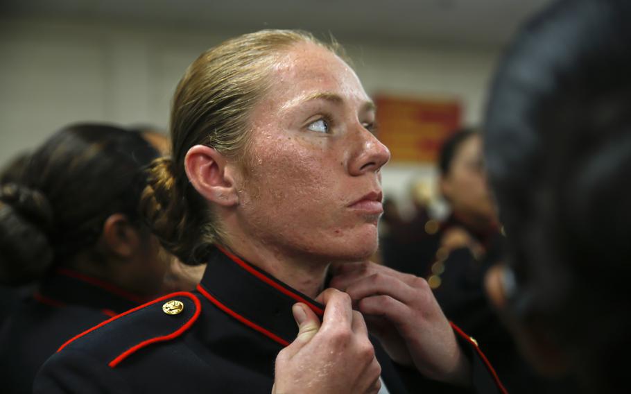 Recruits with Platoon 4040, Papa Company, 4th Recruit Training Battalion, try on their blue dress coats for the first time Aug. 21, 2018, on Parris Island, S.C. The recruits are part of the first female company to be issued the new female blues dress coat, which features a mandarin collar.
