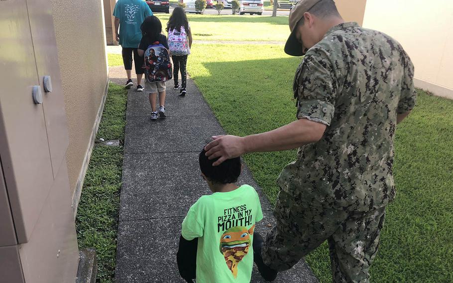 Chief Petty Officer Richard Fowler III walks with his son, Moises, 5, to Ikego Elementary School in Japan, Monday, Aug. 27, 2017. Moises will start kindergarten next week, but his siblings in second and fourth grades began Monday.