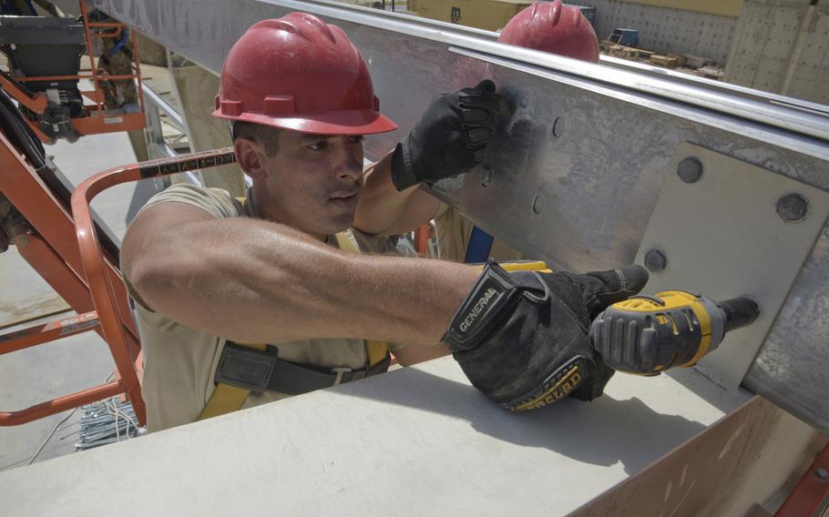 Staff Sgt. John Sikora tightens bolts on a framework for a new hangar at Bagram Air Field, Afghanistan, Monday, Aug. 27, 2018. Sikora is with the 557th Expeditionary Rapid Engineer Deployable Heavy Operational Repair Squadron Engineers, Al Udeid Air Base, Qatar.