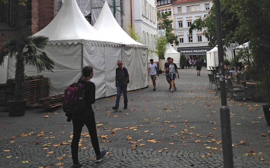 People walk through the Kaiserslautern, Germany pedestrian zone from Stiftsplatz to Marktstrasse on Wednesday, Aug. 30, 2018.