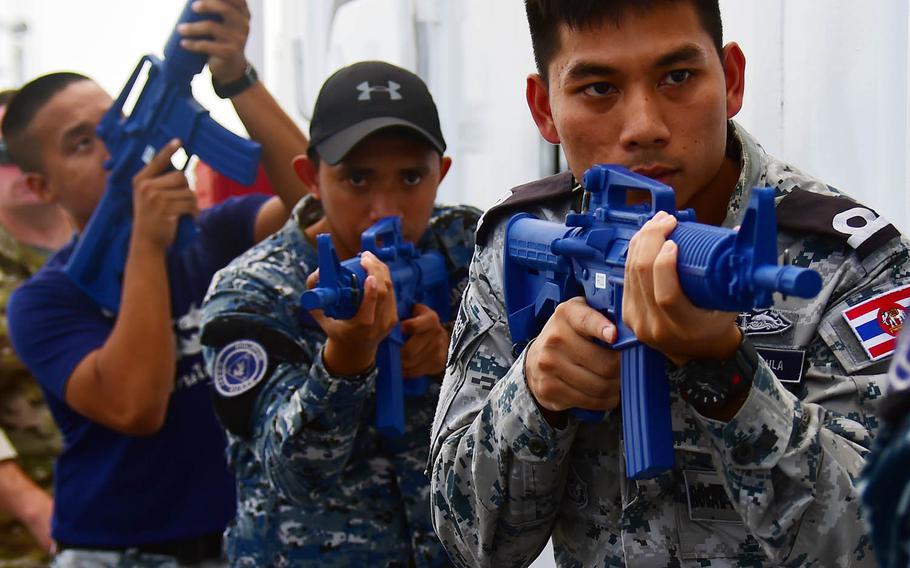 A Royal Thai Navy sailor, right, a Philippine coast guardsman, center, and a Royal Thai Marine police officer practice tactical procedures during Southeast Asia Cooperation and Training in Manila, Philippines, Wednesday, Aug. 29, 2018.