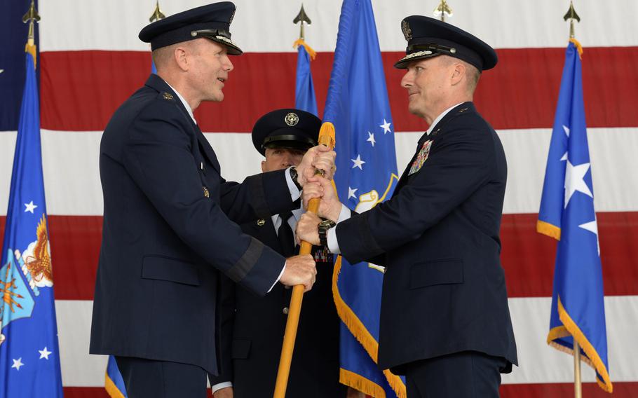 Gen. Tod D. Wolters passes the 3rd Air Force guidon to Maj. Gen. John Wood during the 3rd Air Force change-of-commander ceremony at Ramstein Air Base, Germany, Friday, Sept. 7, 2018.
