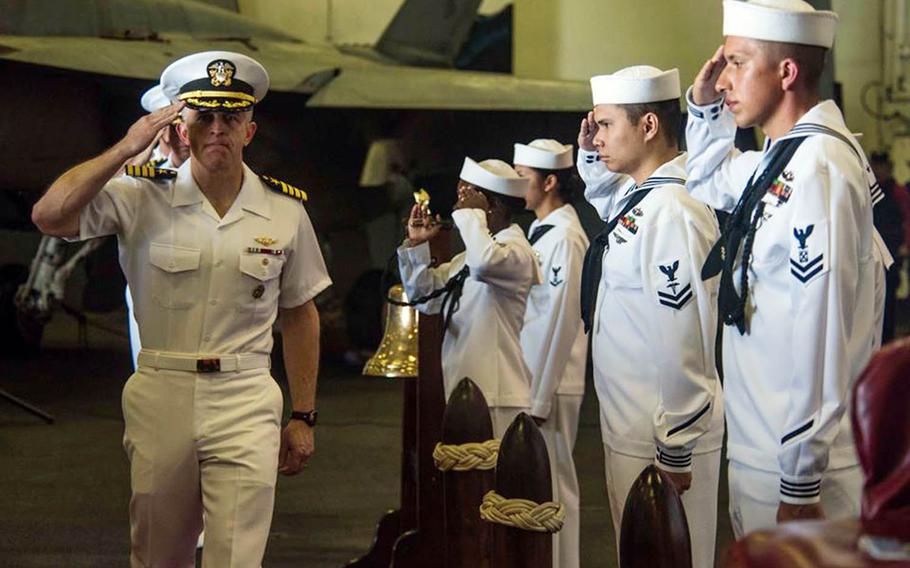 Capt. Patrick "Fin" Hannifin salutes during a change-of-command ceremony aboard the USS Ronald Reagan while at sea, Monday, Sept. 10, 2018.