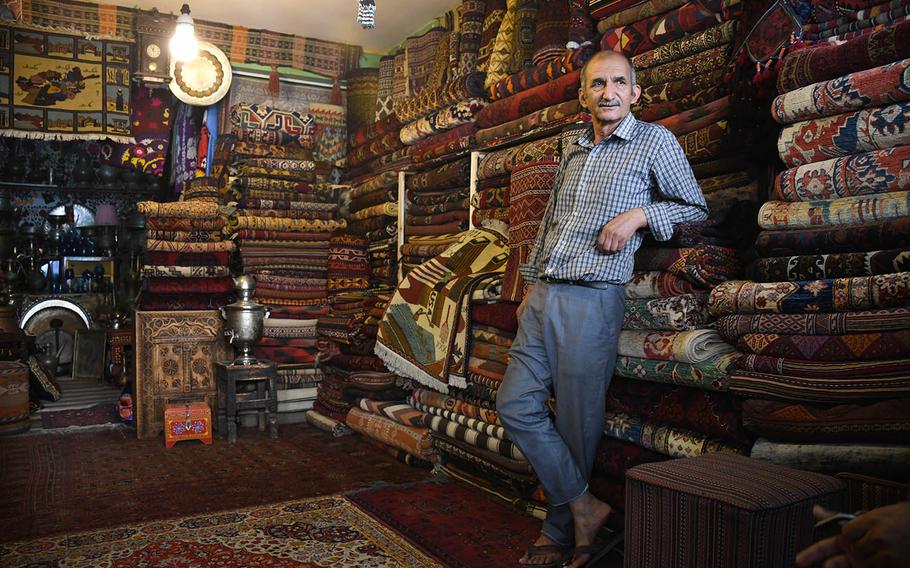 Sayed Jafar, a carpet salesman in Kabul, sells rugs commemorating the attacks of Sept. 11, 2001. As Americans commemorate 9/11, many Afghans either don't know much about it or do not believe the attack happened.