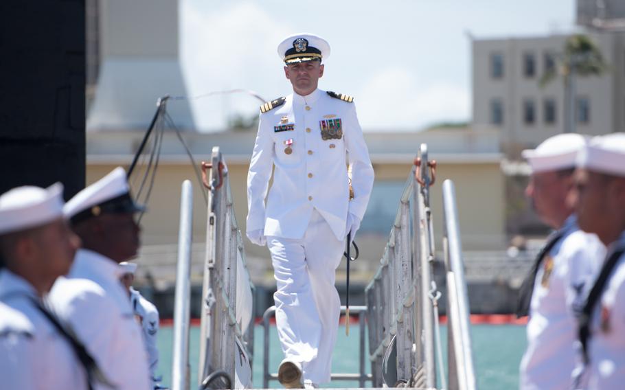 Cmdr. Dave Edgerton, outgoing commanding officer of Los Angles-class fast-attack submarine USS Columbia walks of the submarine after the change-of-command ceremony at Joint Base Pearl Harbor-Hickam, August 3, 2018.