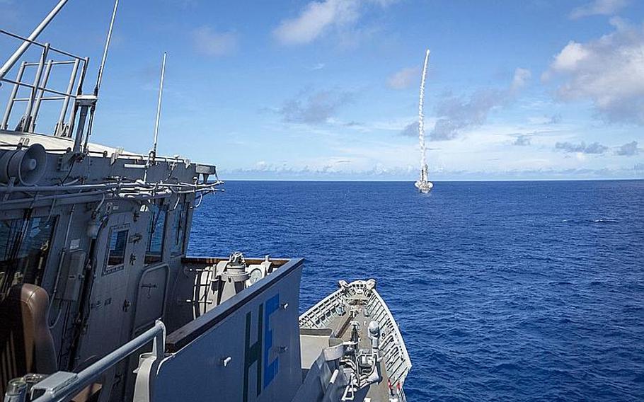 The destroyer USS Milius fires a missile in front of the cruiser USS Chancellorsville during Valiant Shield in the Philippine Sea, Sept. 16, 2018.