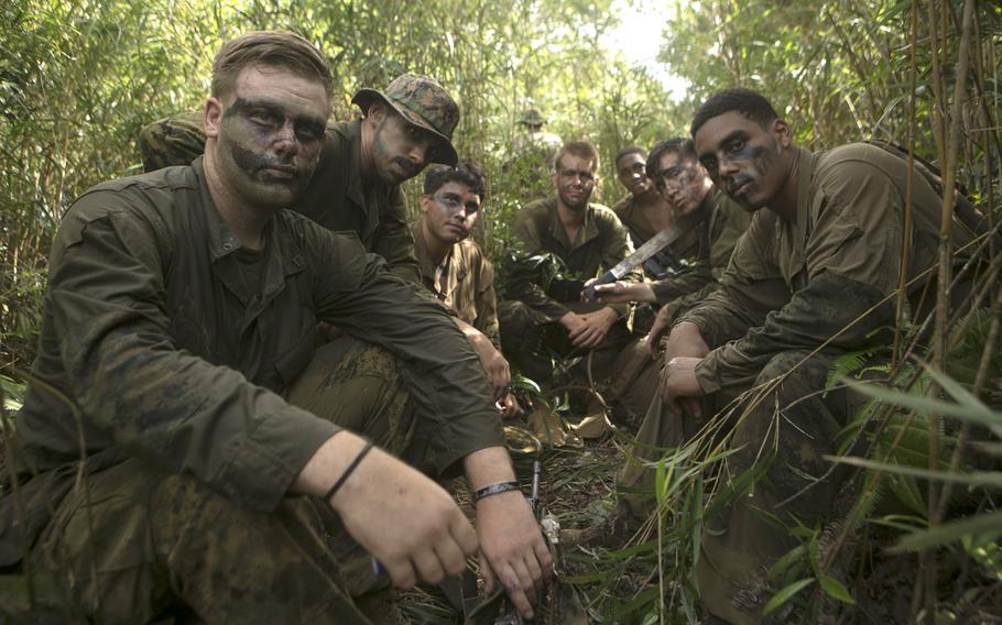 Marines with India Company, 3rd Battalion, 3rd Marine Regiment, take a break on Aug. 3, 2018, at the Jungle Warfare Training Center in Okinawa, Japan. They're wearing their test Marine Corps combat utility uniforms. The new uniforms and boots are supposed to be lighter and faster to dry.