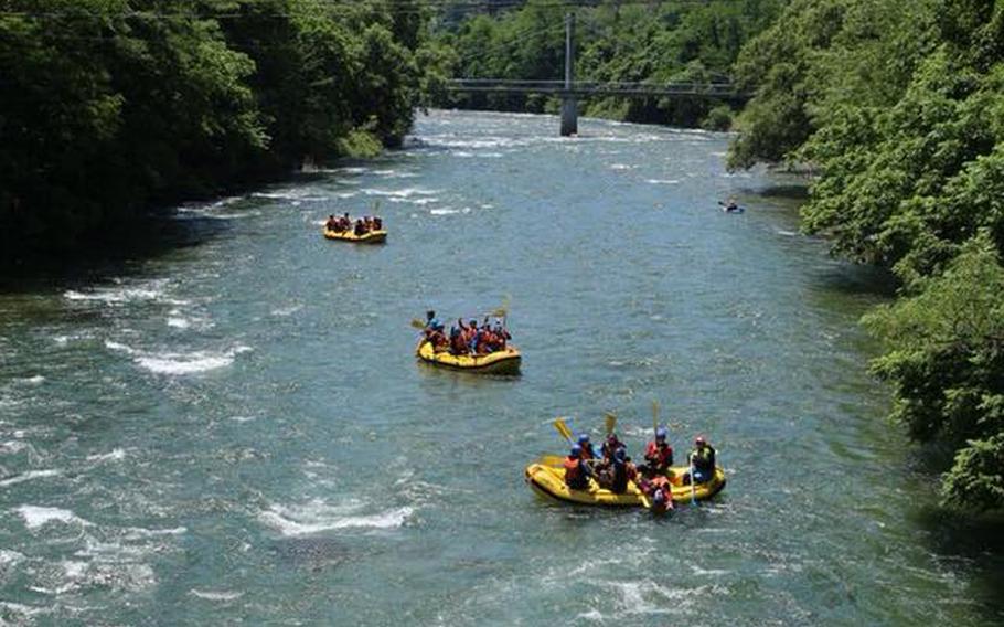 Canyons also offers whitewater rafting excursions throughout Japan. In this photo, three groups of rafters from Yokosuka on an MWR trip in June float down the Tone River among the mountains in Gunma Prefecture. 