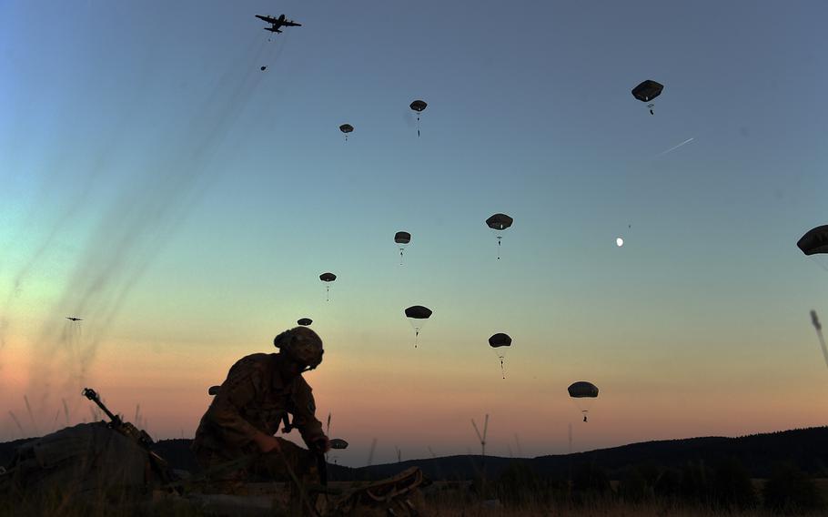 A paratrooper with the 173rd Infantry Brigade Combat Team (Airborne) packs his parachute as more soldiers jump to the ground Wednesday, Sept. 19, 2018, during Exercise Saber Junction 18 at Hohenfels, Germany.