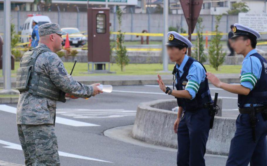 An airmen offers cold drinks to Japanese policemen during the annual Japanese-American Friendship Festival at Yokota Air Base, Japan, Sept. 16. 2018.