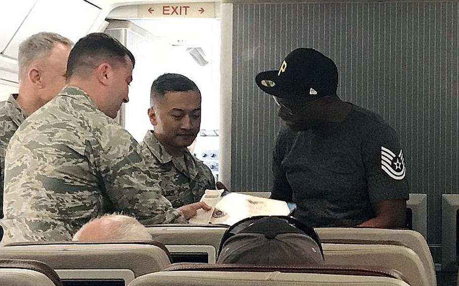 Terry White receives a surprise promotion to technical sergeant aboard a Patriot Express flight before leaving Osan Air Base, South Korea, Thursday, Sept. 27, 2018.