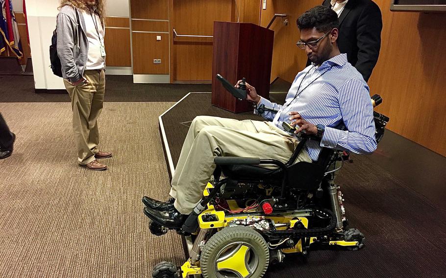 Sivashankar Sivakanthan, a student and graduate researcher with the Human Engineering Research Laboratories program at the University of Pittsburgh, shows how a MEBot reconfigures its wheels to negotiate a curb on Wednesday Oct. 3, in Wiesbaden, Germany. The MEBot, a new type of robotic wheelchair, promises greater independence and mobility for paralyzed veterans.