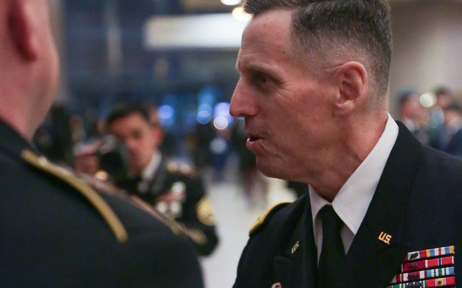 Lt. Gen. Thomas Vandal presents coins to the Eighth Army Band after a concert in Seoul, South Korea, Dec. 17, 2017.