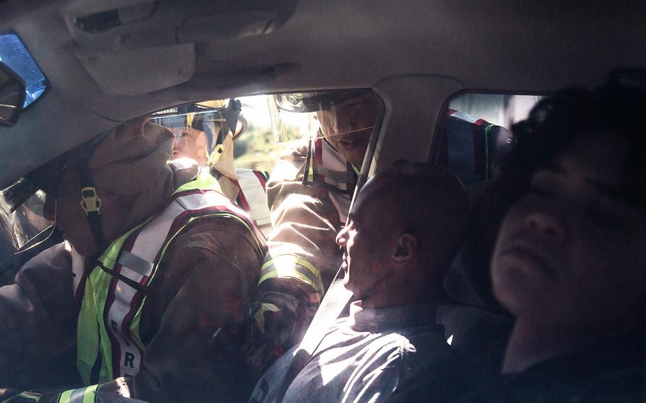 Firefighters rescue people from a vehicle during an exercise at Yongsan Garrison in Seoul, South Korea, Thursday, Oct. 11, 2018.