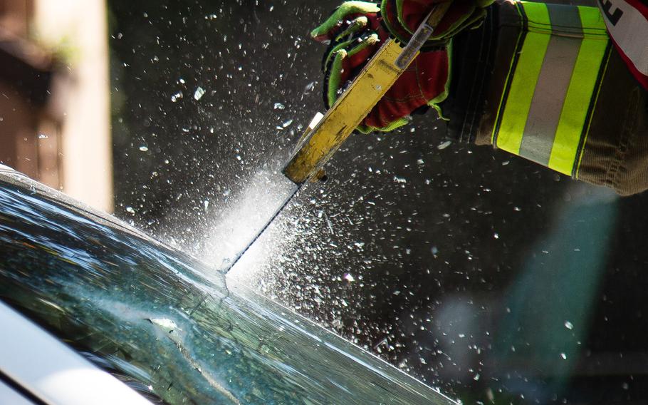 A firefighter saws through a car windshield during an exercise at Yongsan Garrison in Seoul, South Korea, Thursday, Oct. 11, 2018.