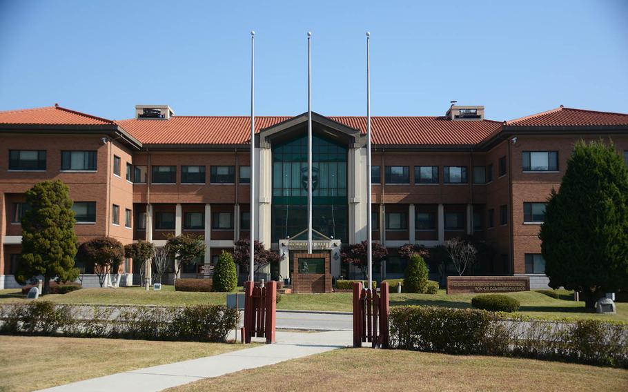 Empty flag poles stand in front of Freeman Hall, the longtime 2nd Infantry Division headquarters at Camp Red Cloud, Sunday, Oct. 21, 2018.