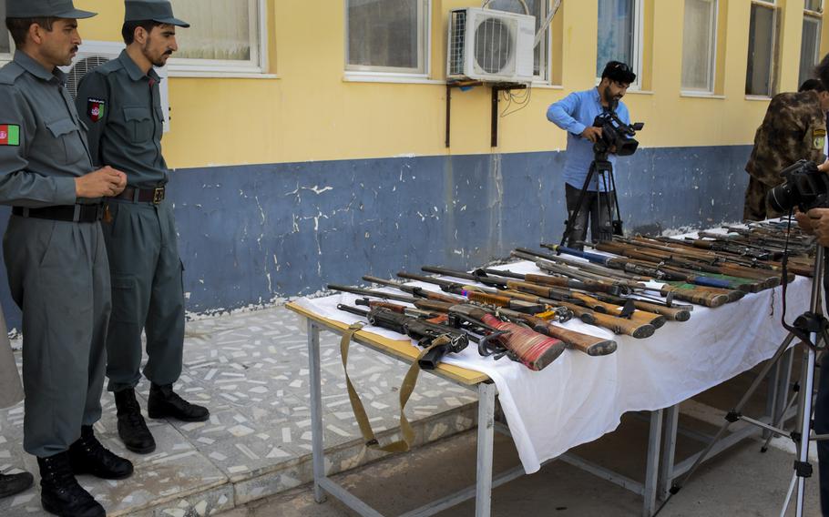 Police officials display 129 weapons they say they seized from militants fighting the government in Herat province in western Afghanistan on June 4, 2018. Infighting between Taliban factions had led to 40 deaths recently, Herat officials said Nov. 2, 2018.