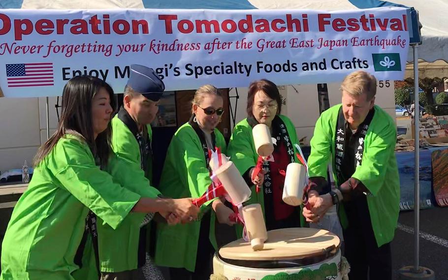 U.S. military and Miyagi prefecture officials crack open a barrel of sake to kick off the Operation Tomodachi Festival at Yokota Air Base, Japan, Saturday, Nov. 3, 2018.