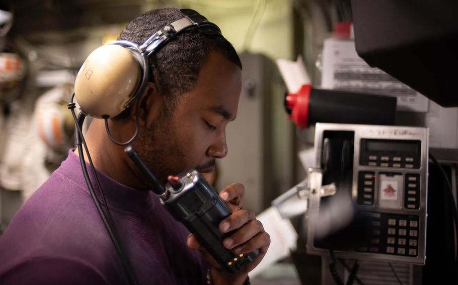 A sailor coordinates the refueling of an F-18 Super Hornet during Keen Sword drills aboard the USS Ronald Reagan, Saturday, Nov. 3, 2018.