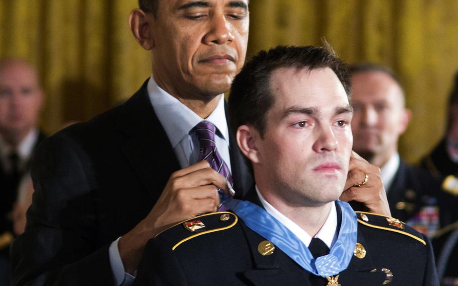 President Barack Obama presents the Medal of Honor to former Army Staff Sgt. Clinton Romesha during a ceremony at the White House, Feb. 11, 2013.