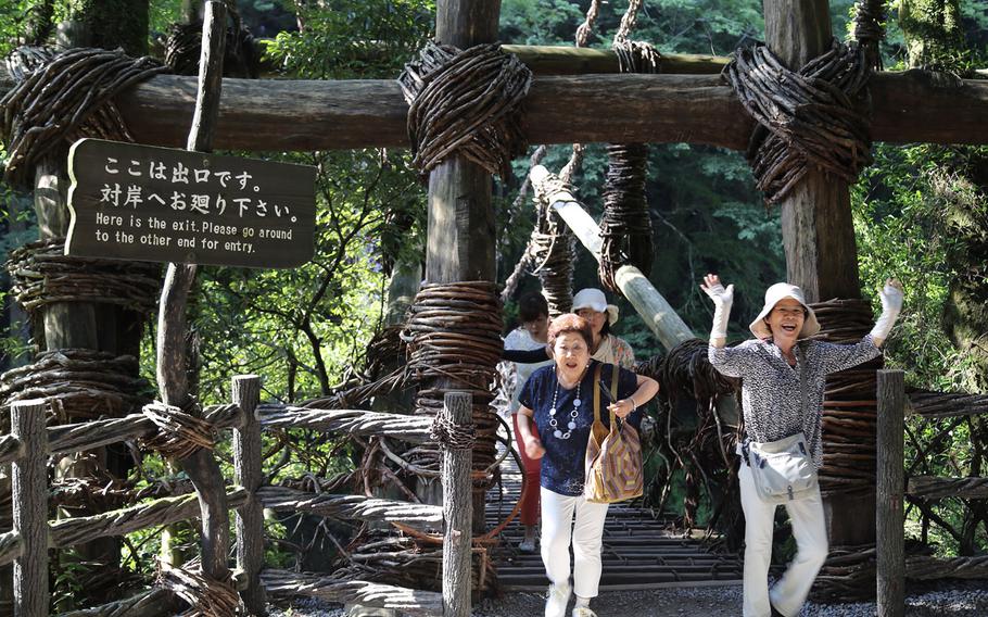 A visitor to the Kazura Bridge completes the 45-meter walk across the bridge.