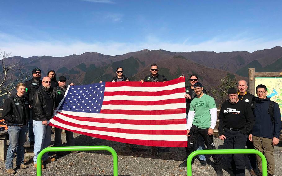 Motorcyclists from the U.S. military riding community carried a flag through the mountains west of Tokyo on Saturday, Nov. 17, 2018, in memory of Master Sgt. Nicholas Vollweiler, 35, who was recently stabbed to death near Yokota Air Base, Japan.
