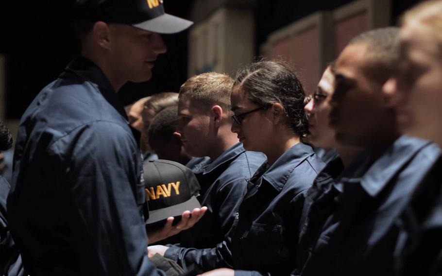 Sailors receive Navy ball caps during a recent boot camp at Recruit Training Command in Great Lakes, Ill.