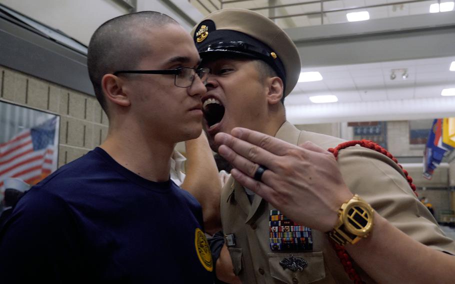 Chief Petty Officer Jaime Kalaw disciplines a recruit during a recent boot camp at Recruit Training Command in Great Lakes, Ill.