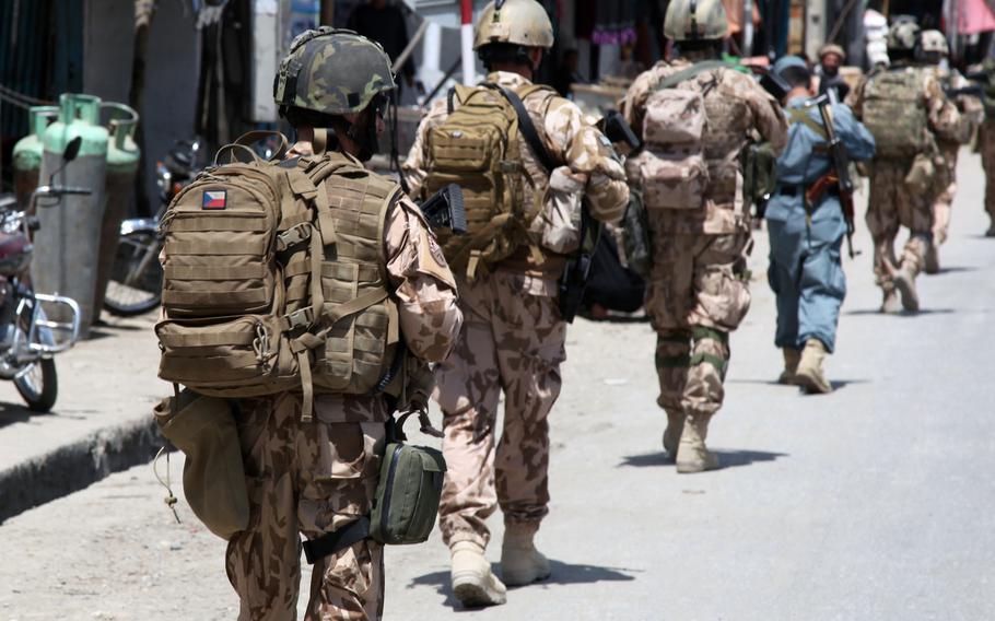 Czech soldiers patrol through Dihi Babi village, Parwan province, Afghanistan. American and Czech troops are being investigated for allegedly beating an Afghan commando to death last month following an insider attack that killed a Czech soldier.