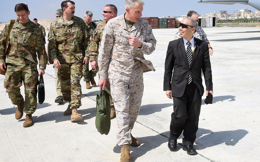 U.S. Marine Gen. Thomas D. Waldhauser speaks with U.S. Ambassador to Somalia Donald Yamamoto at Aden Adde International Airport in Mogadishu, Somalia, Nov. 27, 2018.