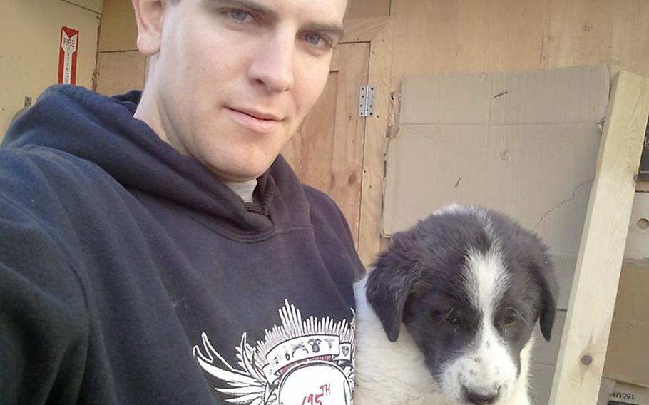 Spc. Kevin Shumaker holds a puppy on Combat Outpost Base Chamkani, Afghanistan. Shumaker, 24, died of rabies in August 2011, seven months after being bitten by a dog while breaking up a dog fight on the base. His death was the first confirmed military rabies death in 40 years, and an investigation revealed a series of mistakes and omissions in treating him.