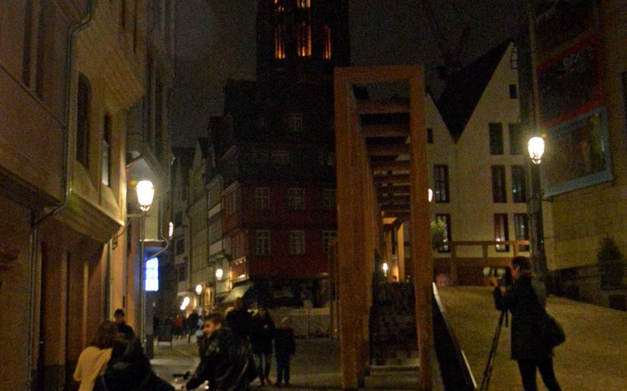 A night time view of the Frankfurt cathedral through the new Altstadt, or Old Town, along ''Coronation Way,'' the path newly crowned emperors walked from the cathedral to the Roemer, Frankfurt's city hall.