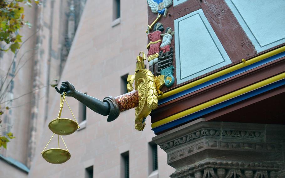 An arm holding a golden scale adorns the facade of the Goldene Waage, one of the houses reconstructed during the building of Frankfurt's new Old Town. A renaissance half-timbered house, it was destroyed in World War II.