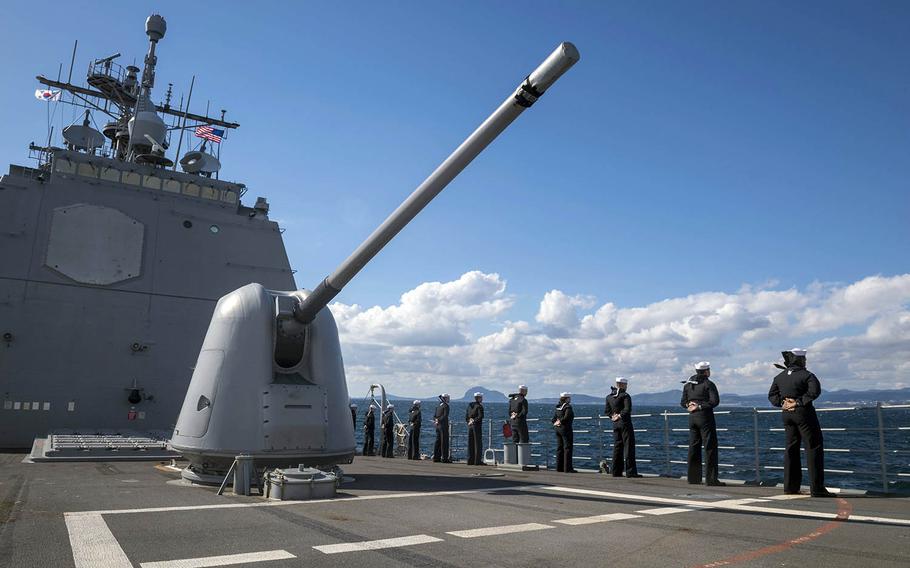 Sailors man the rails aboard the guided-missile cruiser USS Chancellorsville in waters off the Korean Peninsula, Oct. 11, 2018.