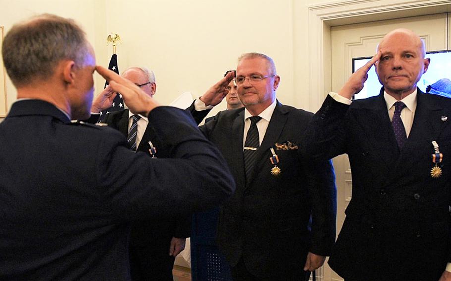U.S. Air Force Maj. Gen. John Williams, Mobilization Assistant to the commander, U.S. Air Forces in Europe- Air Forces Africa, salutes the Swedish pilots who were awarded the U.S. Air Medal in Stockholm, Sweden, on Nov. 28, 2018. Gen. Williams thanked the four pilots who risked their lives to save an SR-71 and the two Americans on board in 1987.