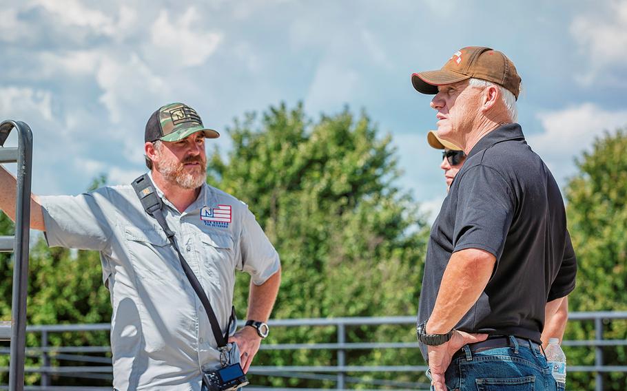 John Parker, development director, photographer and Navy veteran, talks with a couple of combat veterans during a War Horses for Veterans summer group.