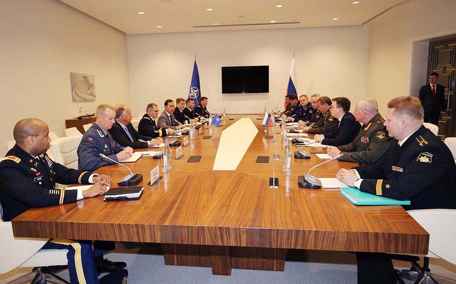 Gen. Curtis M. Scaparrotti, NATO supreme allied commander Europe, and Gen. Valery Gerasimov, Russian armed forces chief of staff, are seated behind their respective flags in Baku, Azerbaijan, April 19, 2018. The two will meet in Baku again today.