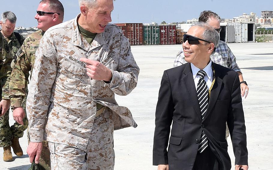 Marine Gen. Thomas D. Waldhauser, commander of U.S. Africa Command, speaks with U.S. Ambassador to Somalia Donald Yamamoto at the Mogadishu airport Nov. 27, 2018. During his visit, Waldhauser also met with Somali President Mohamed Abdullahi Mohamed. The Pentagon denied Monday that there is a plan to reduce its mission in Somalia and cease airstrikes against militants in the country.