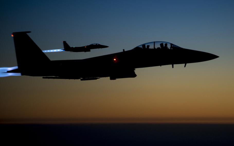 A pair of U.S. Air Force F-15E Strike Eagles fly over northern Iraq in 2014, after conducting airstrikes in Syria. Military officials are refuting claims that civilians were harmed in a coalition airstrike on an Islamic State-held village in eastern Syria last week.