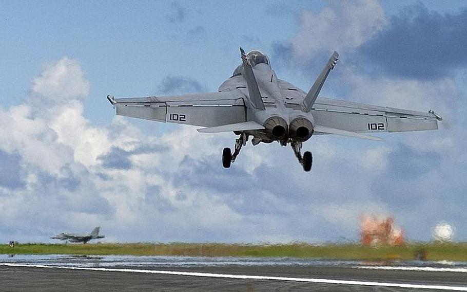 An FA-18/F Super Hornet takes part in field carrier-landing practice on the Japanese island of Iwo To, formerly known as Iwo Jima, in 2007.