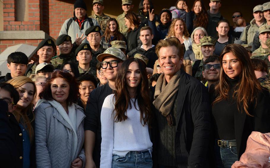 "Transformers" star Megan Fox poses for a photo with soldiers and other fans outside the theater at Yongsan Garrison in Seoul, South Korea, Wednesday, Jan. 9, 2019.