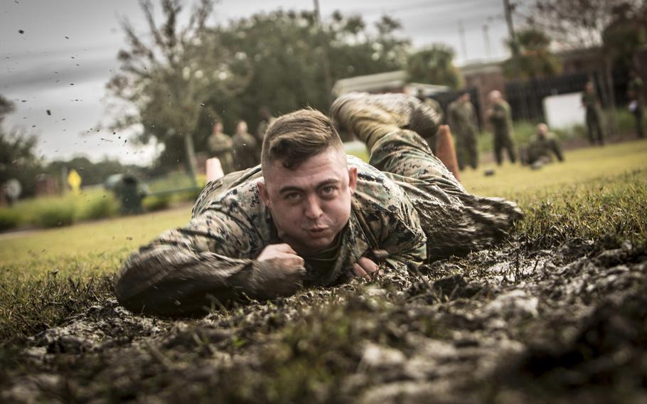 Cpl. Darrell Reynolds, 4th Marine Logistics Group, Marine Forces Reserve, low crawls during the maneuver under fire portion of the combat fitness test at Marine Corps Support Facility New Orleans, Dec. 14, 2018.