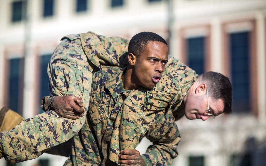 A Marine with Marine Forces Reserve conducts a fireman carry during the maneuver under fire portion of the combat fitness test at Marine Corps Support Facility New Orleans, Dec. 21, 2018.