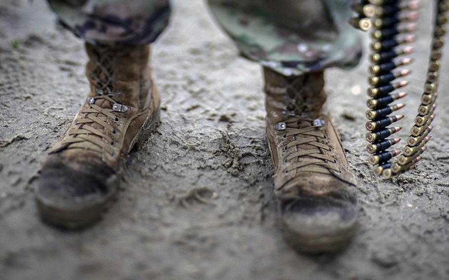 The Army is testing new combat boots in a push to better compete with the more comfortable commercial brands favored by many soldiers for their lightness. Here, a soldier from the 1-114th Infantry Regiment stands in the mud holding 7.62mm ammunition during training on Joint Base McGuire-Dix-Lakehurst, N.J., Nov. 6, 2018.