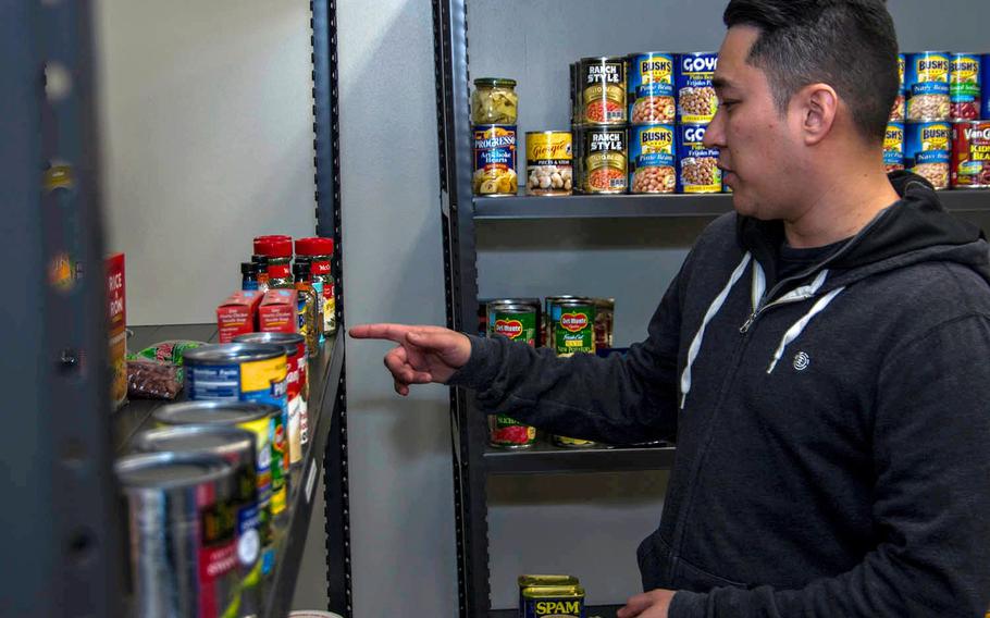 Information Systems Technician 1 Joseph Bruce takes donated items from the food pantry at Yokota Air Base, Japan, Thursday, Jan. 24, 2019.