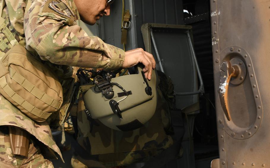 Afghan pilot Maj. Abdul Rahman Rahmani inspects his Russian-made helicopter between missions Dec. 12, 2018, in Kabul, Afghanistan.