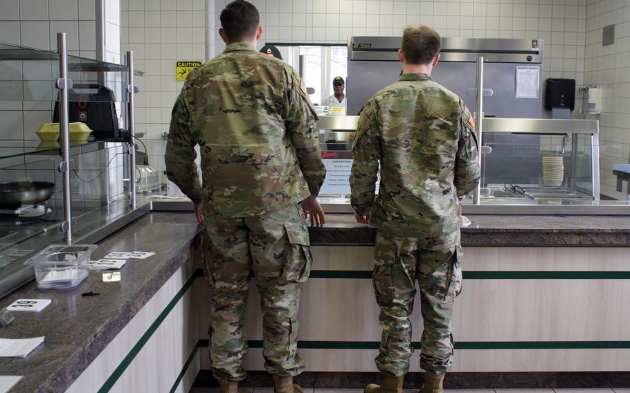 Troops with the 10th Special Forces Group get a meal at their dining facility at Panzer Kaserne, which began offering free meals Friday to members of the Stuttgart military community not getting paid because of the government shutdown.