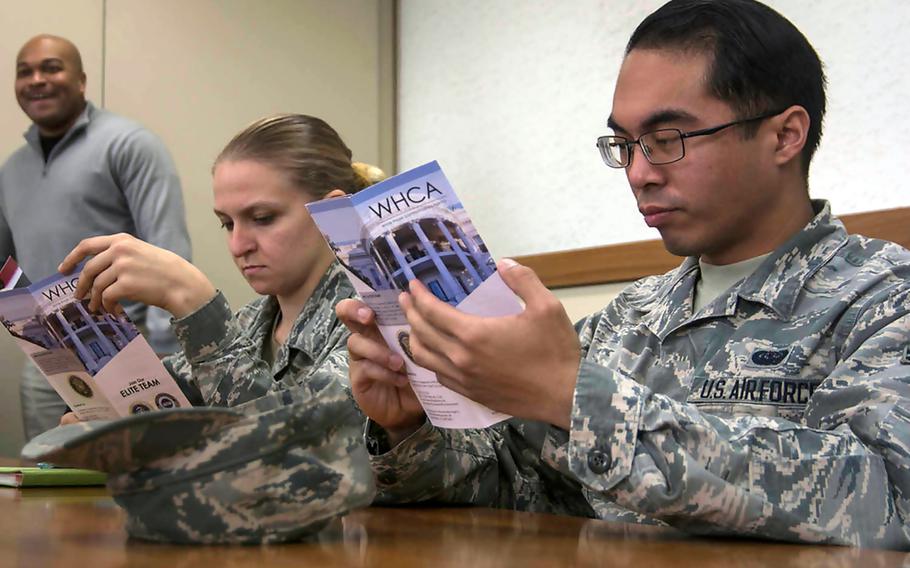 Servicemembers attend a recruiting seminar hosted by the White House Communications Agency at Yokota Air Base, Japan, Monday, Jan. 28, 2019.